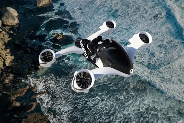 A 3D rendering of the UDX Airwolf flying over the coast