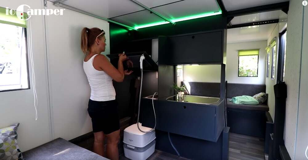 The ioCamper's central wall houses a kitchen unit and washroom with privacy curtain
