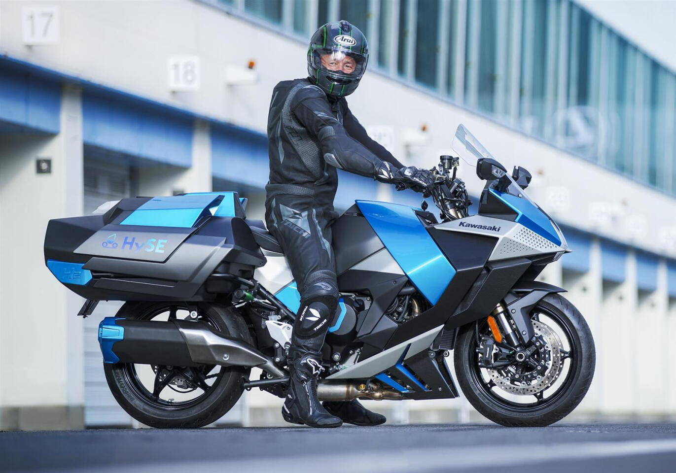 The prototype's modified combustion engine burns hydrogen supplied from oversized tanks to the rear of the rider