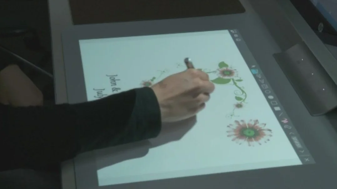 Users can add to an image displayed on the 20-inch touch-enabled mat using a finger or a supplied stylus