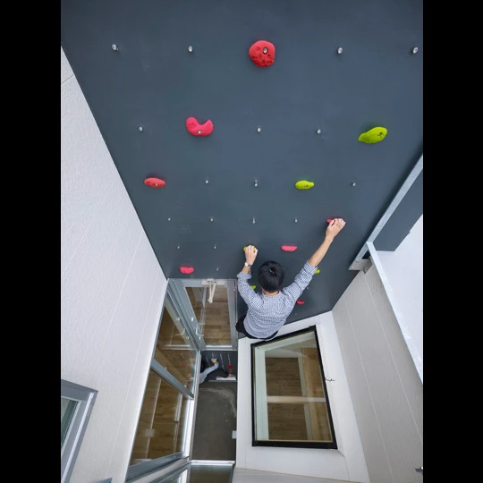 3way House is a creative family home that features a series of climbing walls and ladders to keep the family active