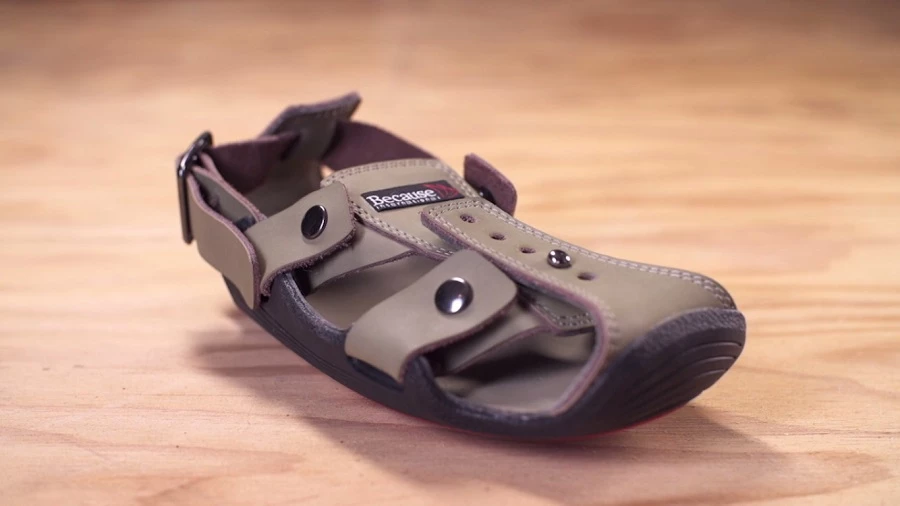 Snap button straps at the side of The Shoe That Grows adjust its width