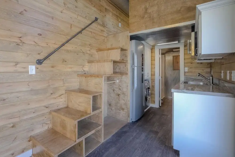 Storage-integrated stairs lead to the container's sleeping loft