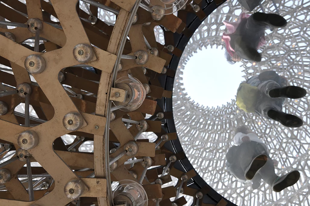 Individual aluminum parts are assembled together following the Fibonacci sequence to create an enormous beehive structure