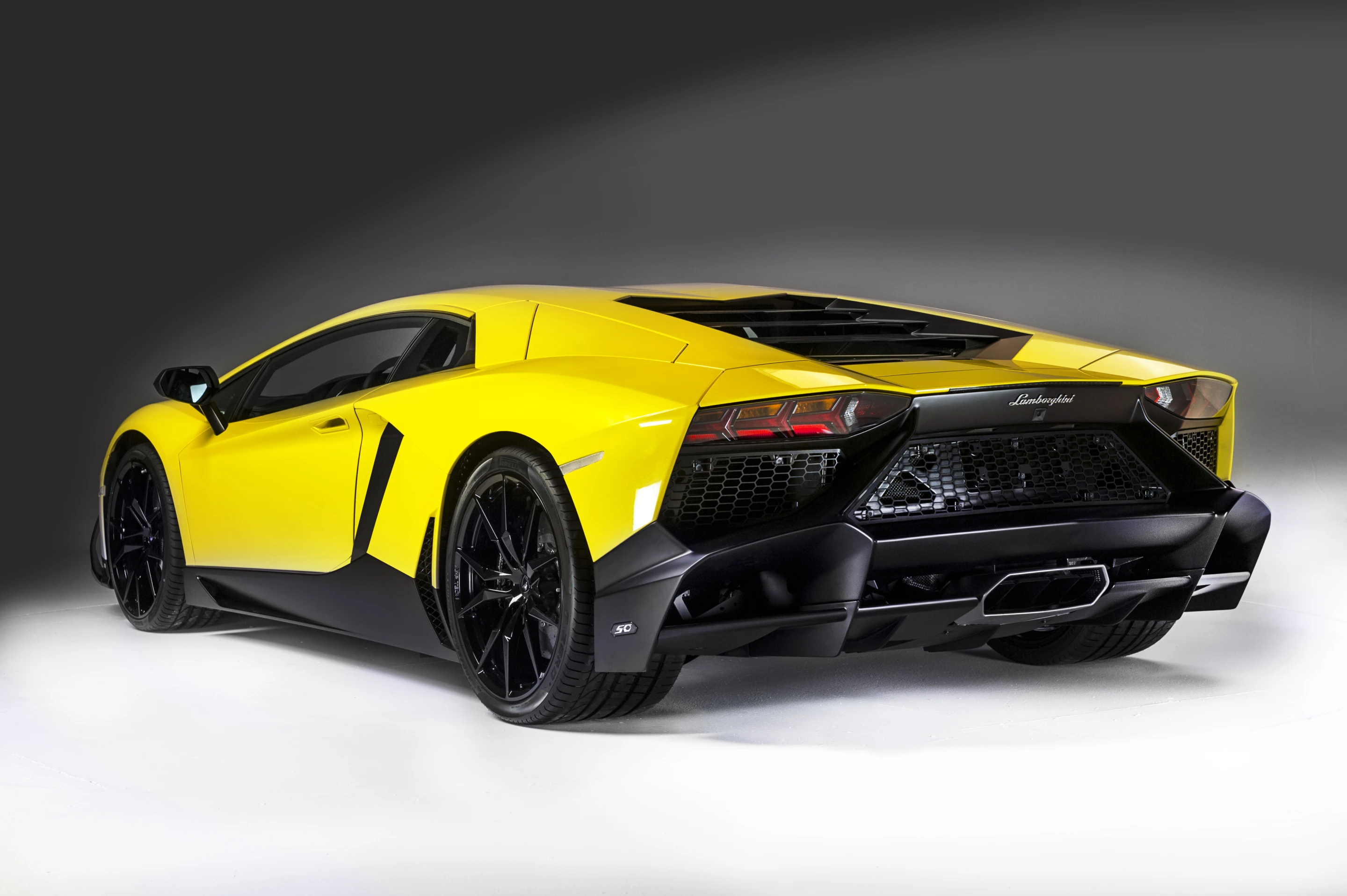 Aventador's rear end is completely new, featuring an enlarged diffuser and expansive meshwork to enhance engine ventilation