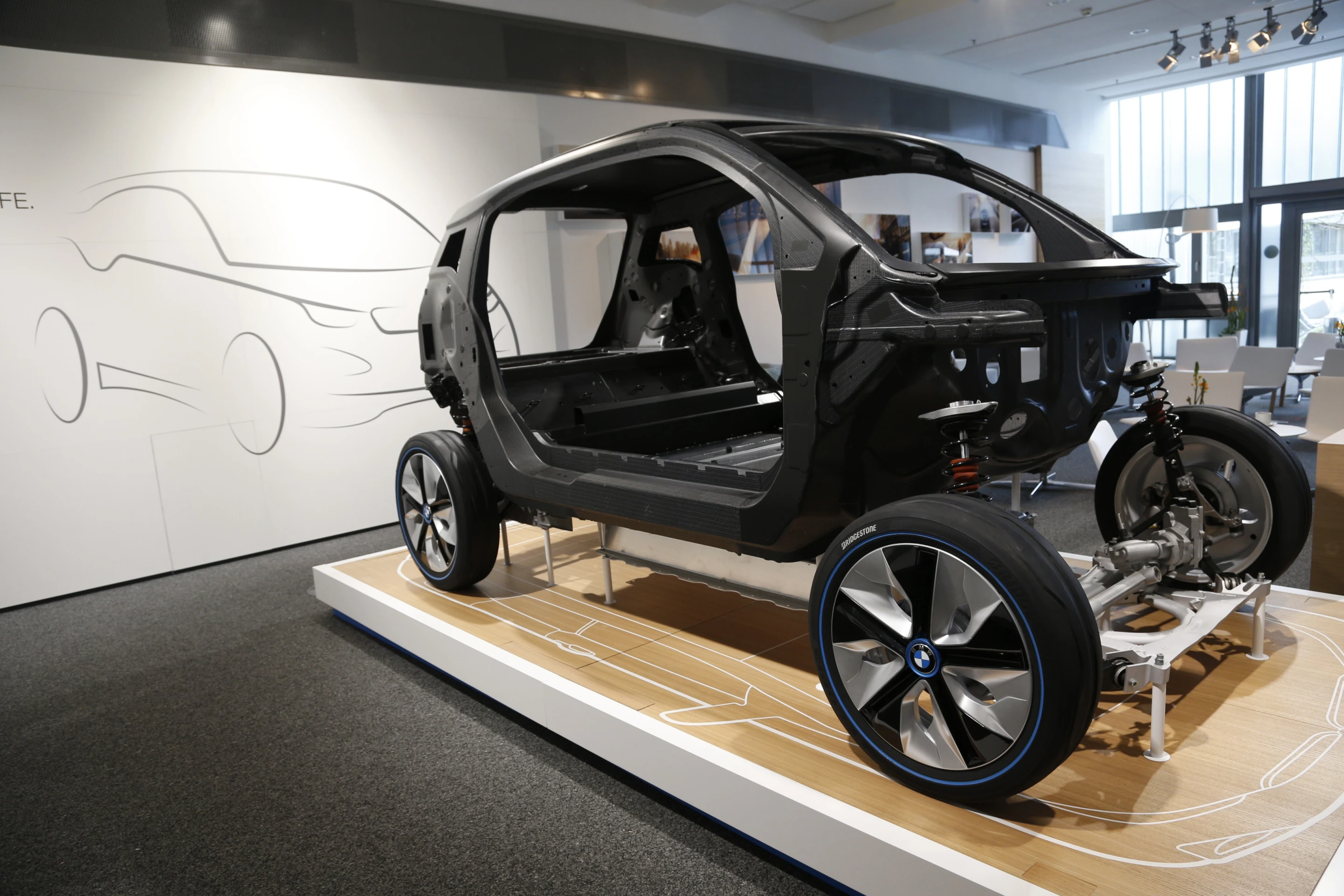 The lower half of the i3's LifeDrive aluminum frame secures the lithium-ion battery underneath providing increased overall cabin space
