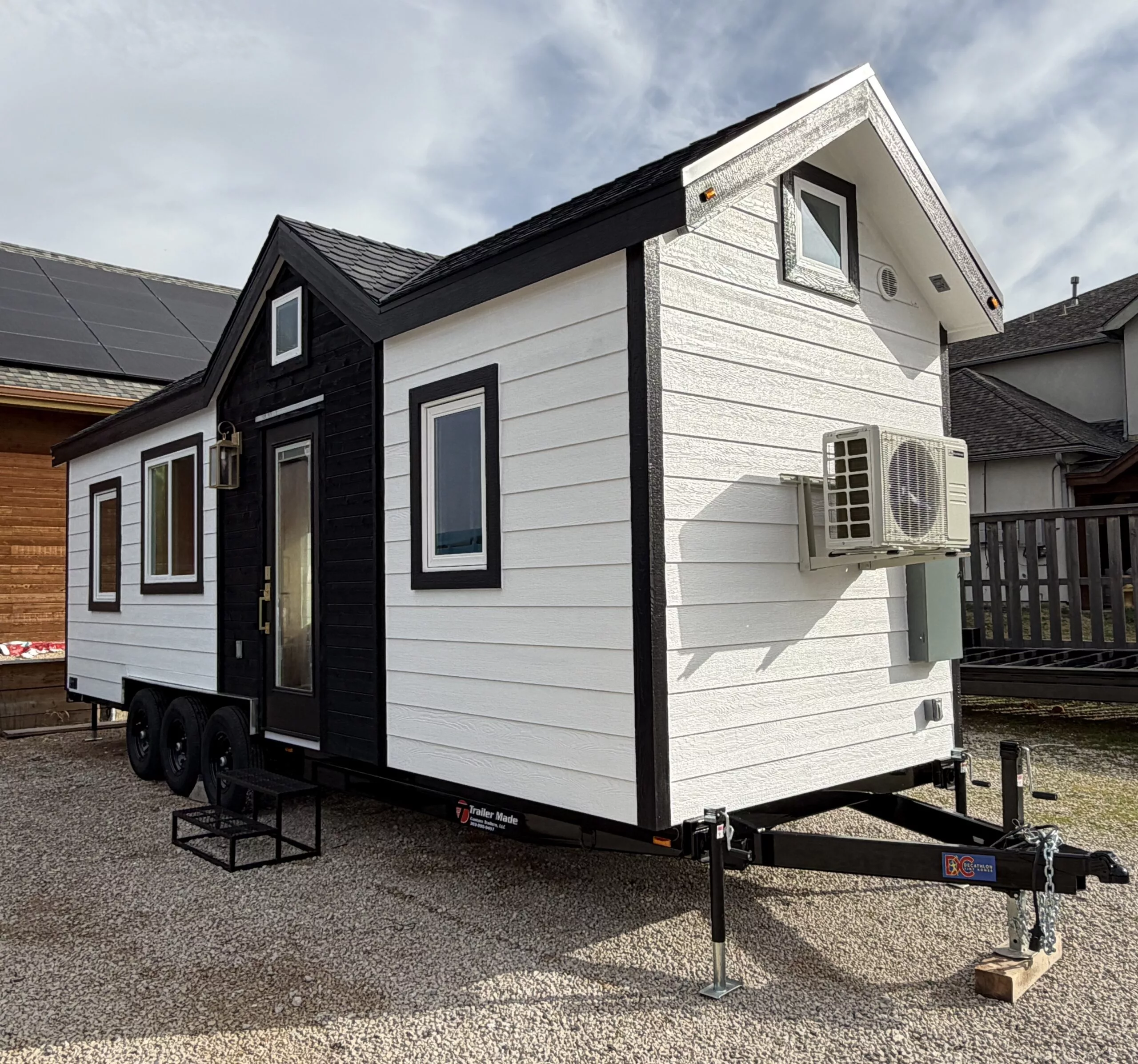 The Betty tiny house is finished in engineered wood and is topped by a composite shingle roof