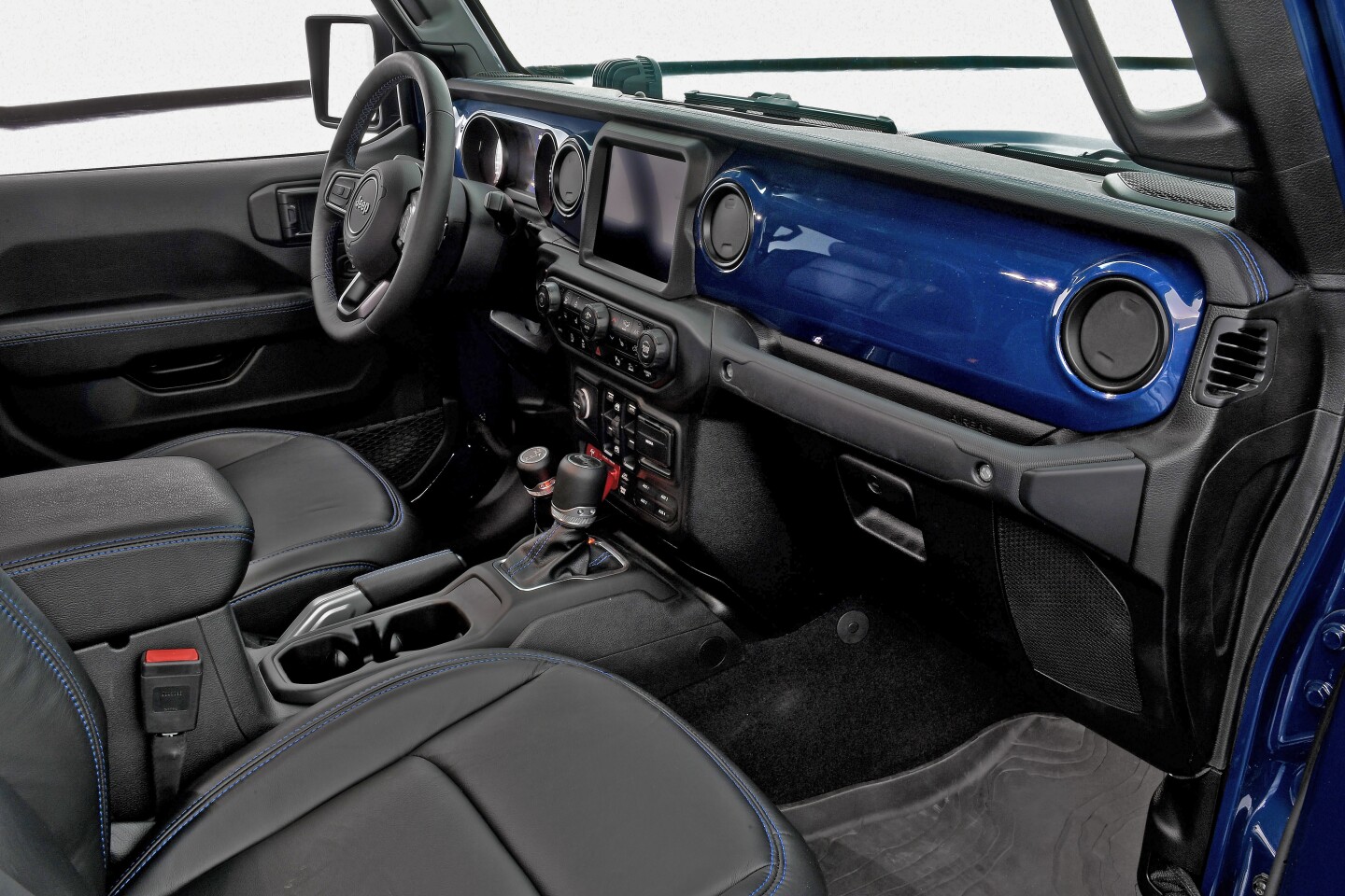 The visual highlight inside is the exterior-matched K9 Blue dashboard facing