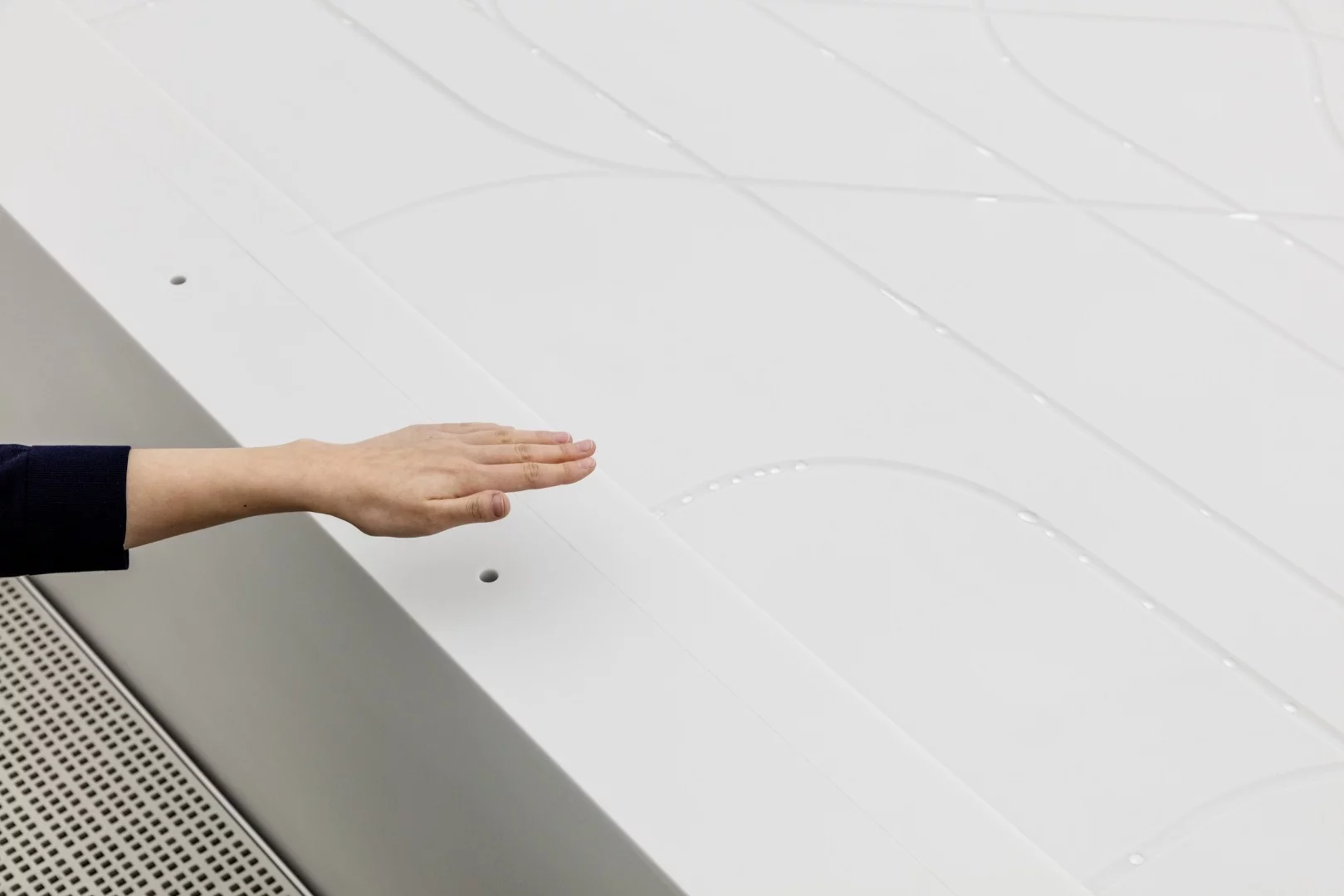 The water installation inside uses water droplets to create a visage resembling the sight of a giant city from space