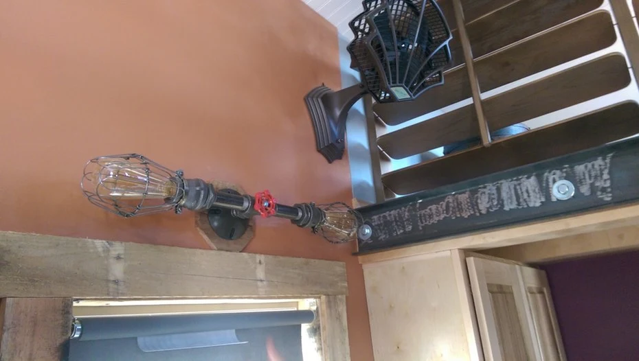 Steampunk Adventure Home's interesting decor includes valves, exposed metal pipework, vintage light fittings, and custom metalwork