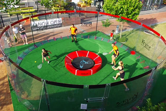 In the new racquet game of 360ball, players hit a ball into a central concave dish, trying to rebound it out of the reach of their opponents