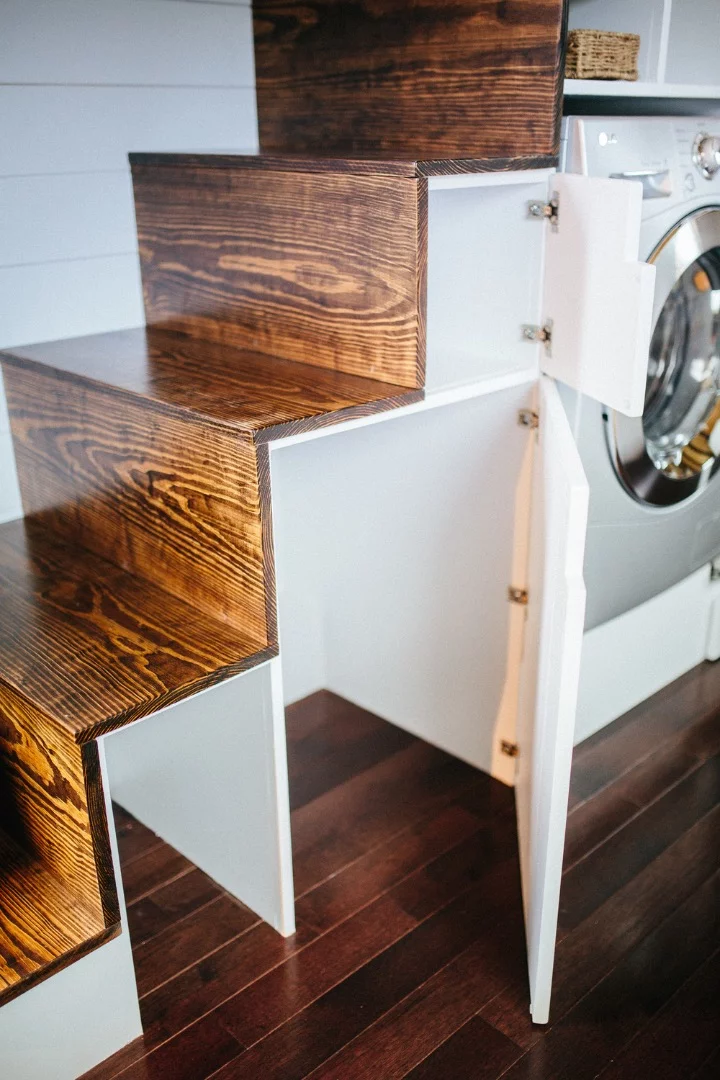 The stairs also include a washer/dryer, fridge, and cupboard space