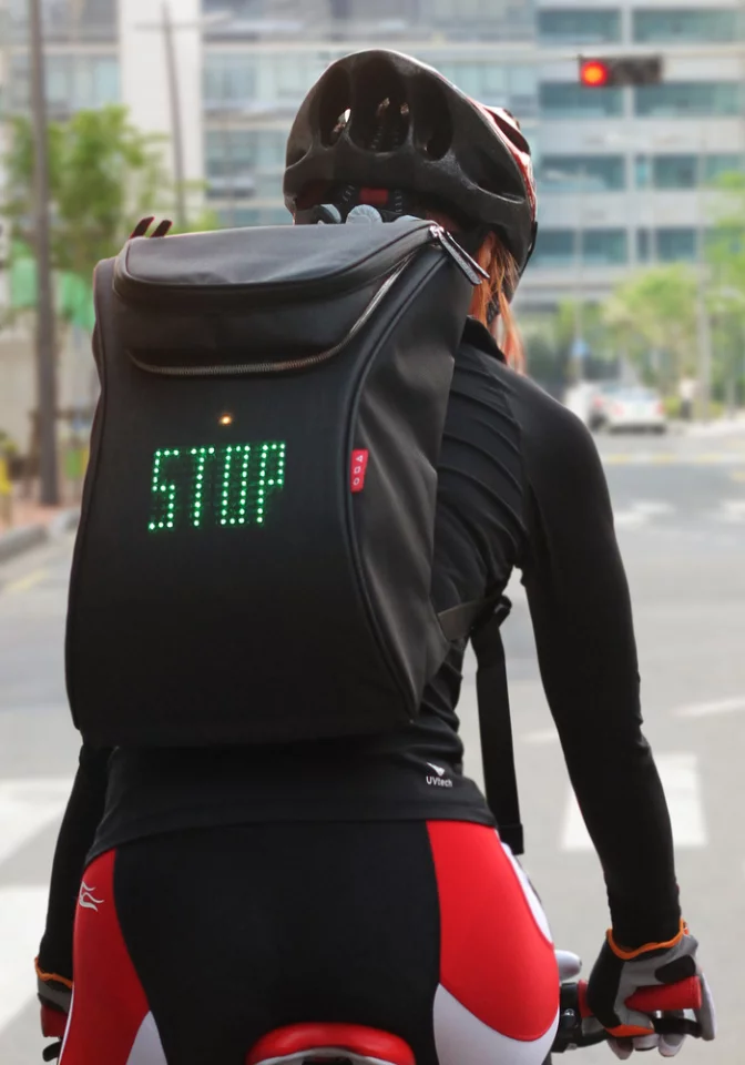 The cyclist activates the stop message on the rear of the SEIL bag