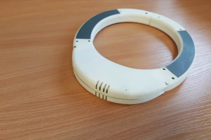 The Buddy Life-Collar is worn around the child's neck as they play near the water