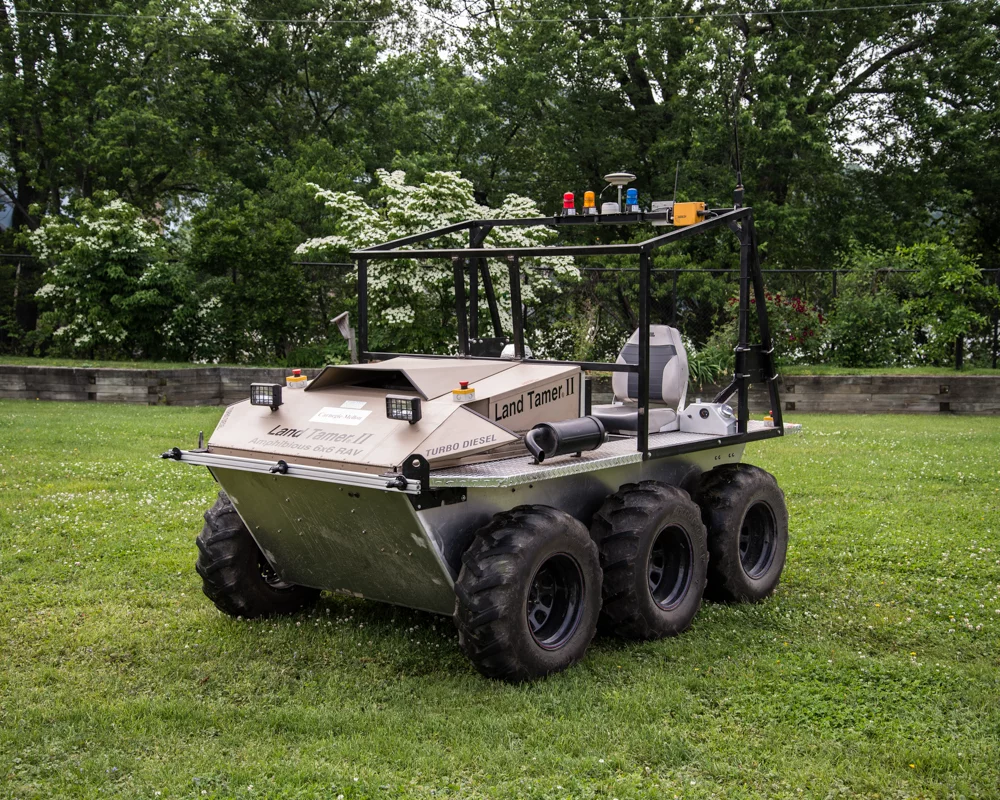The autonomous Land Tamer vehicle, which will be dropped off to explore a rugged area by a likewise-autonomous Black Hawk helicopter