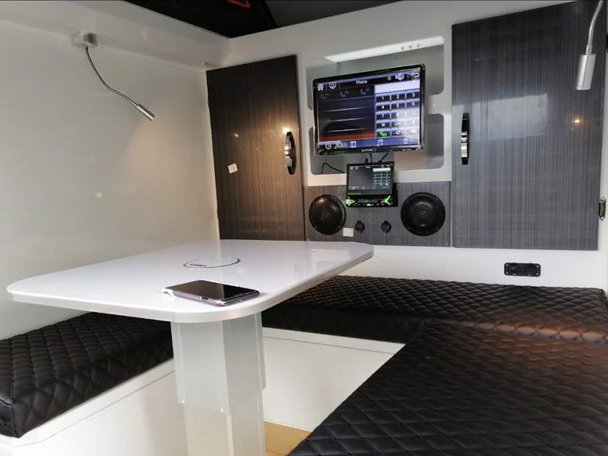 The interior includes a convertible dining lounge and an A/V system