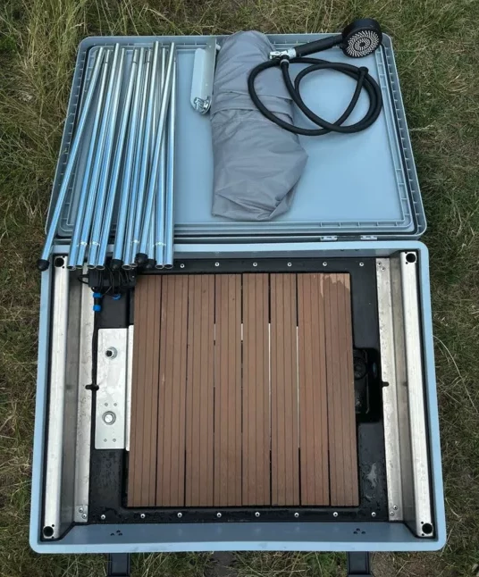 The bathroom module packs a full shower system and comes with a portable dry toilet