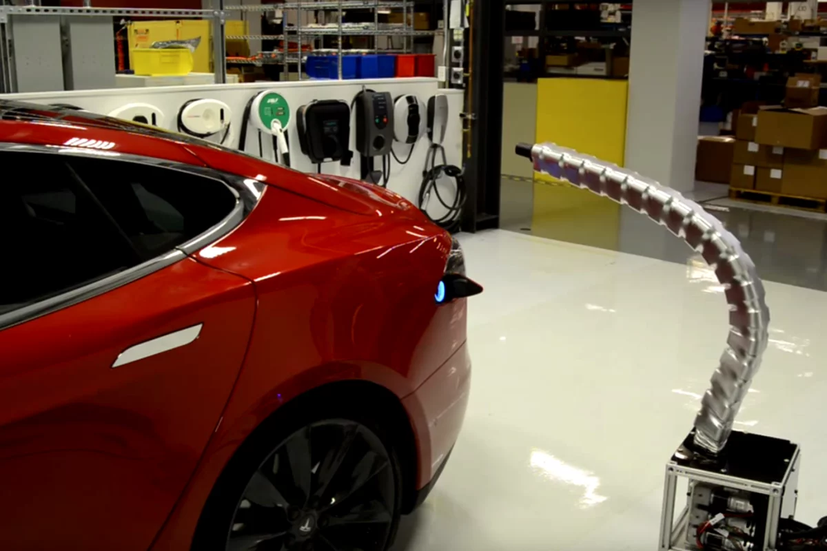 Tesla's prototype robotic charger snaking its way into a Model S