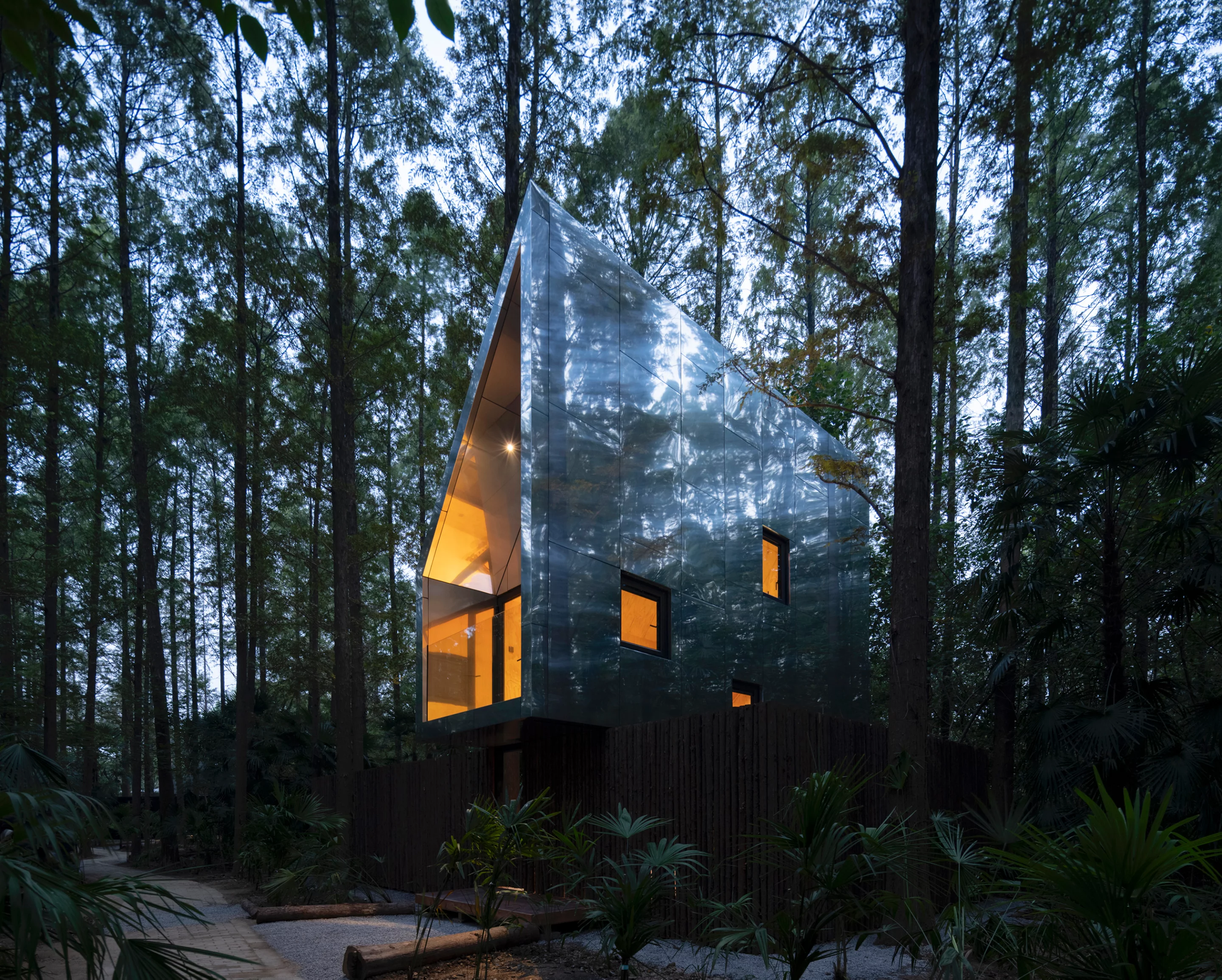 This treehouse rises quietly among the trees at Wiki World–Secret Camp