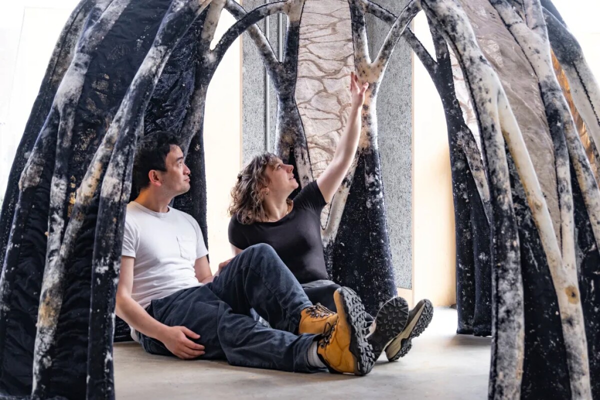 Two of the scientists in the BioKnit dome, which is made of mycocrete