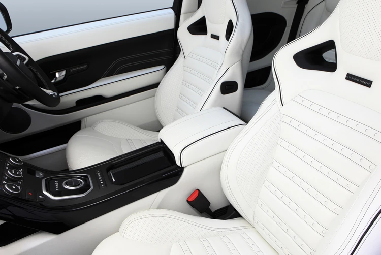 The white leather interior is offset by black veneers, contrast stitching and detailing