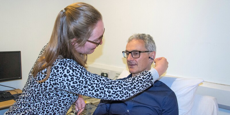 A volunteer prepares for a daily dose of electric stimulation