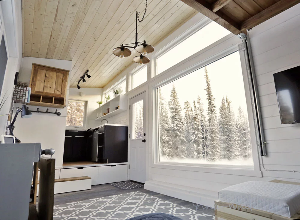 All the Open Concept Rustic Modern Tiny House's windows are triple-glazed