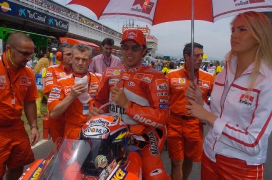 The Ducati is again competitive - at some circuits. That's Capirossi on the grid.