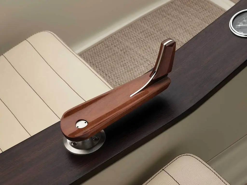 Steering is controlled via a hand-carved wooden tiller
