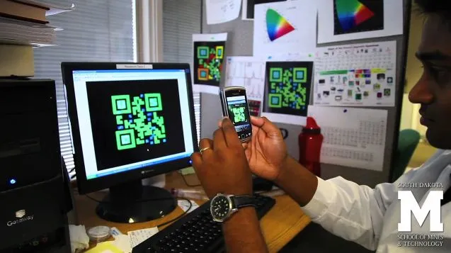 An AutoCAD rendering of one of the QR codes, being read by a smartphone