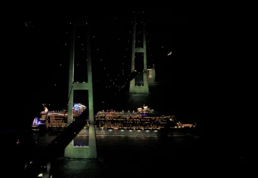 Oasis passes under the great belt bridge in Denmark by retracting her telescopic funnels