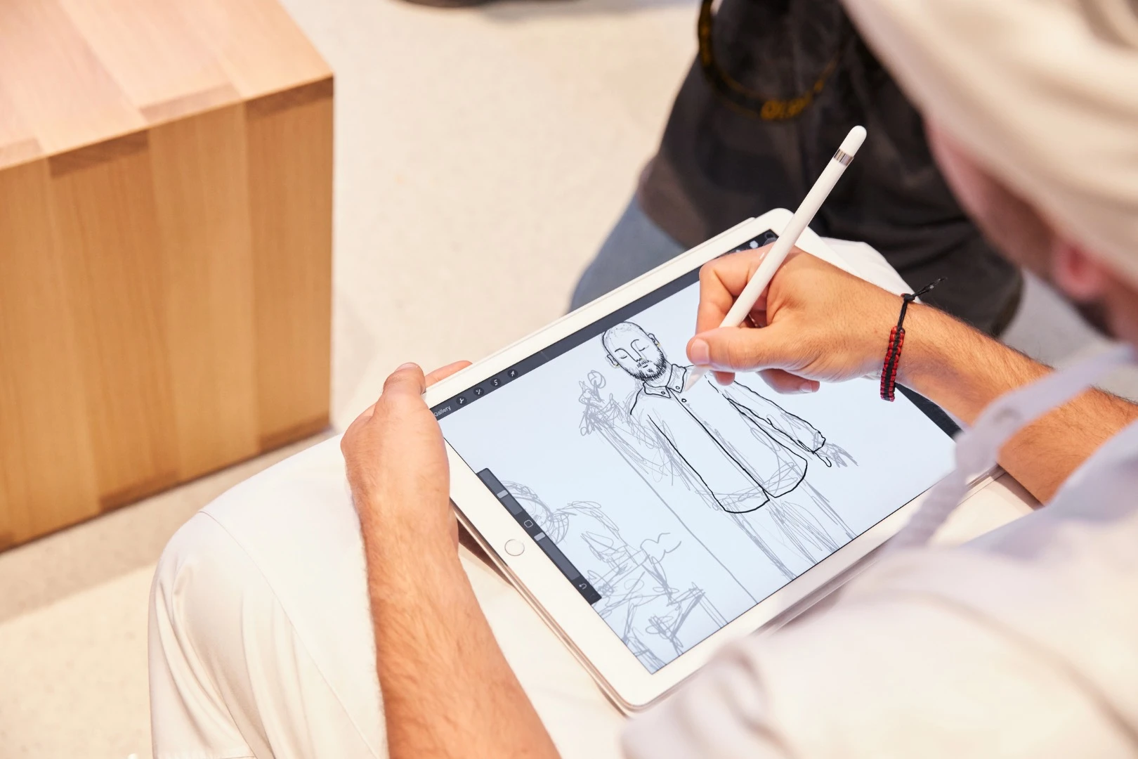 An artist sketching with an iPad Pro at the opening ceremony of the new Apple Store