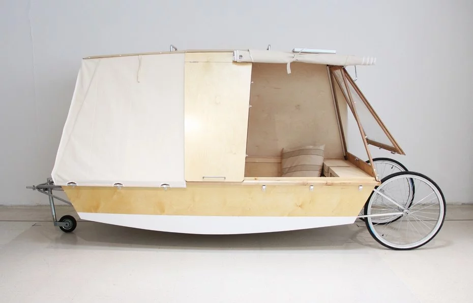 WaterBed's interior includes cushioned seating which transforms into a bed, and a fold-down table