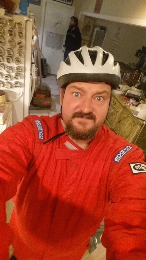 Loz's "safety gear" as he prepares to ride Luke Workman's Death Bike in the dark and the rain, with only a flashlight as a headlight.