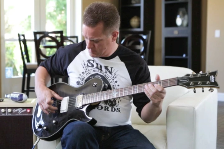 Livermore-based guitarist Brandon McCullough tries out the Dialtone "infinitely adjustable pickup"