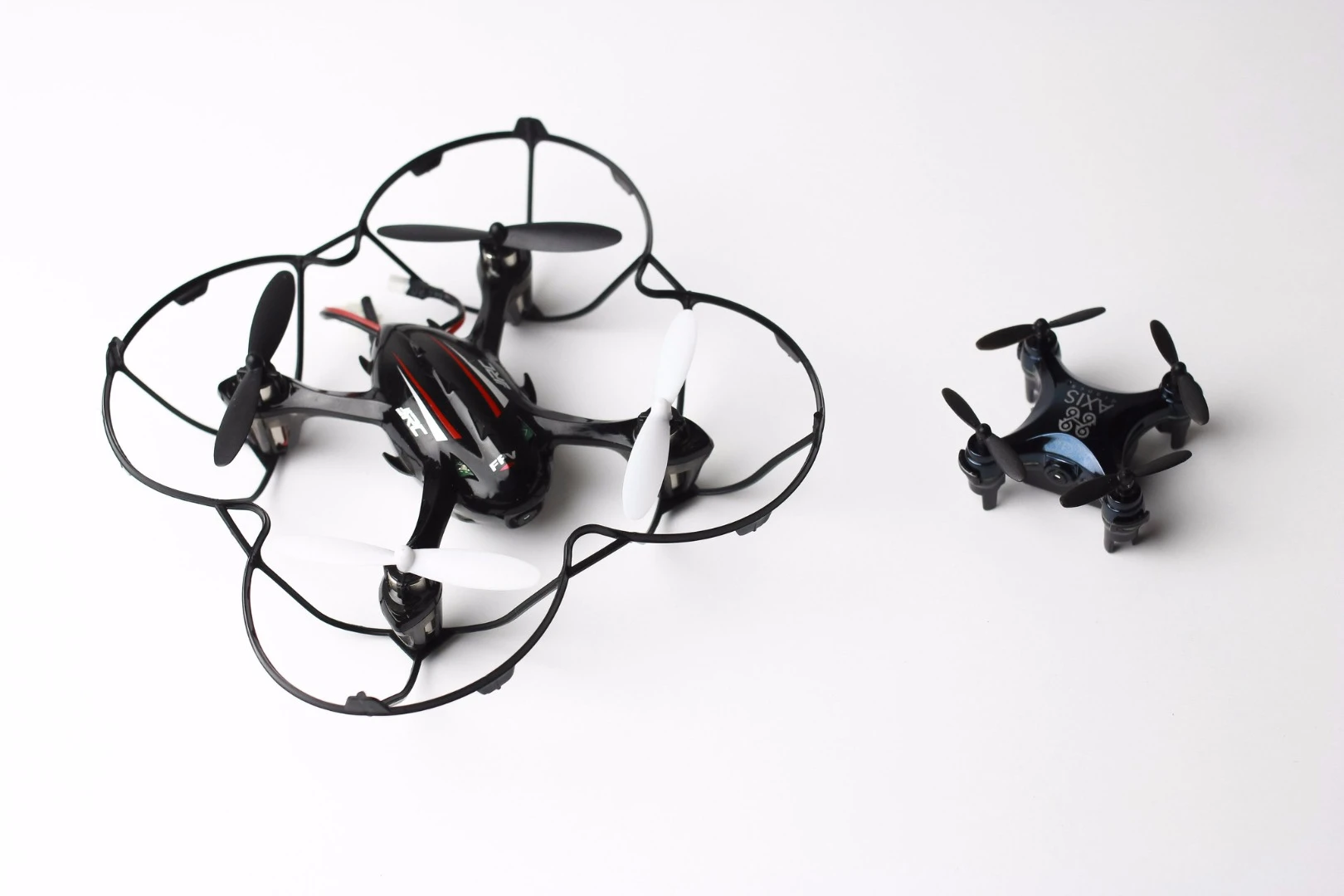 The Vidius (right), as compared in size to an existing "tiny" camera-equipped quadcopter