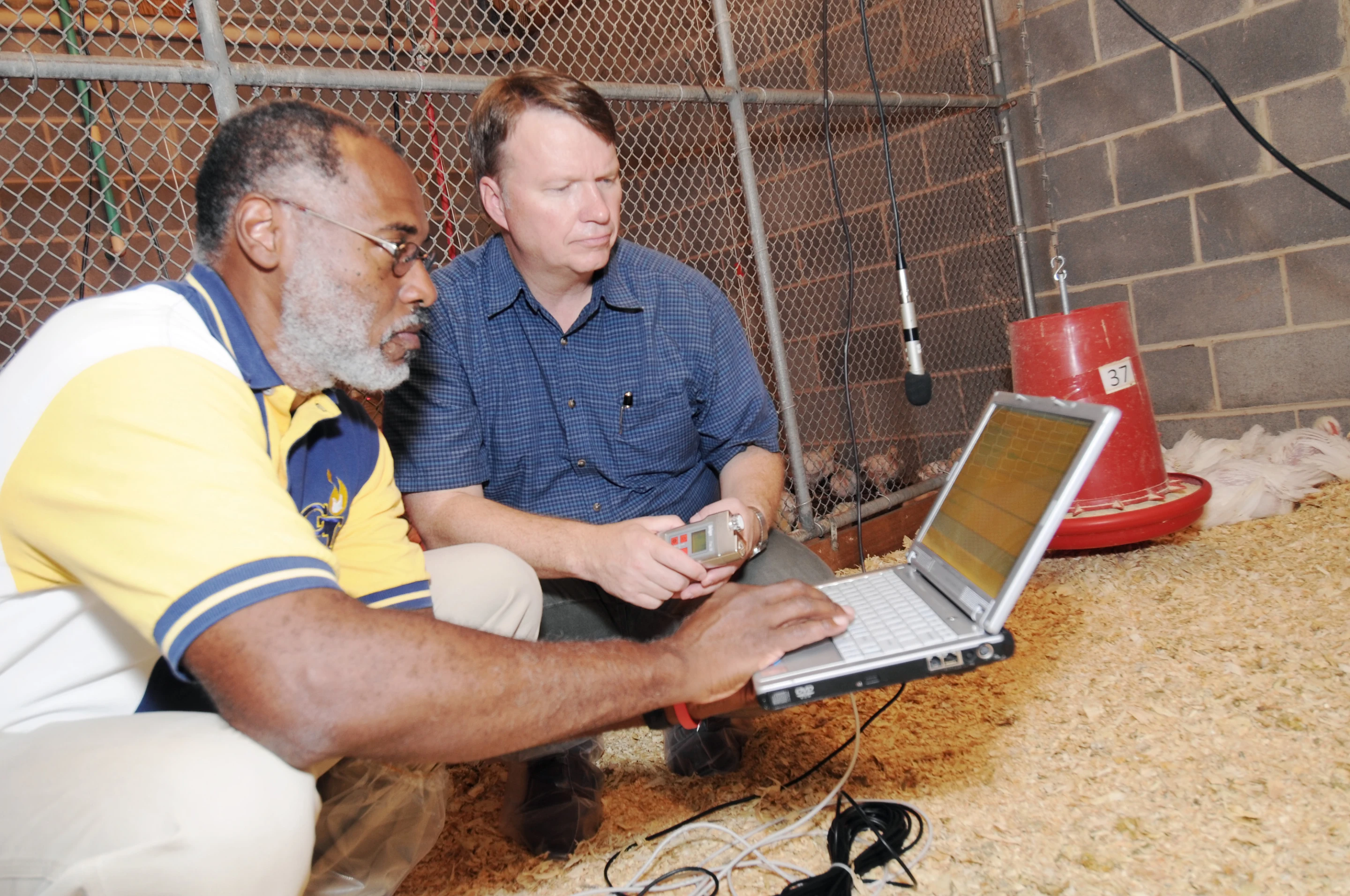 Wayne Daley (left), a Georgia Tech Research Institute principal research scientist, and Casey Ritz, a University of Georgia associate professor of poultry science, prepare to record chicken vocalizations