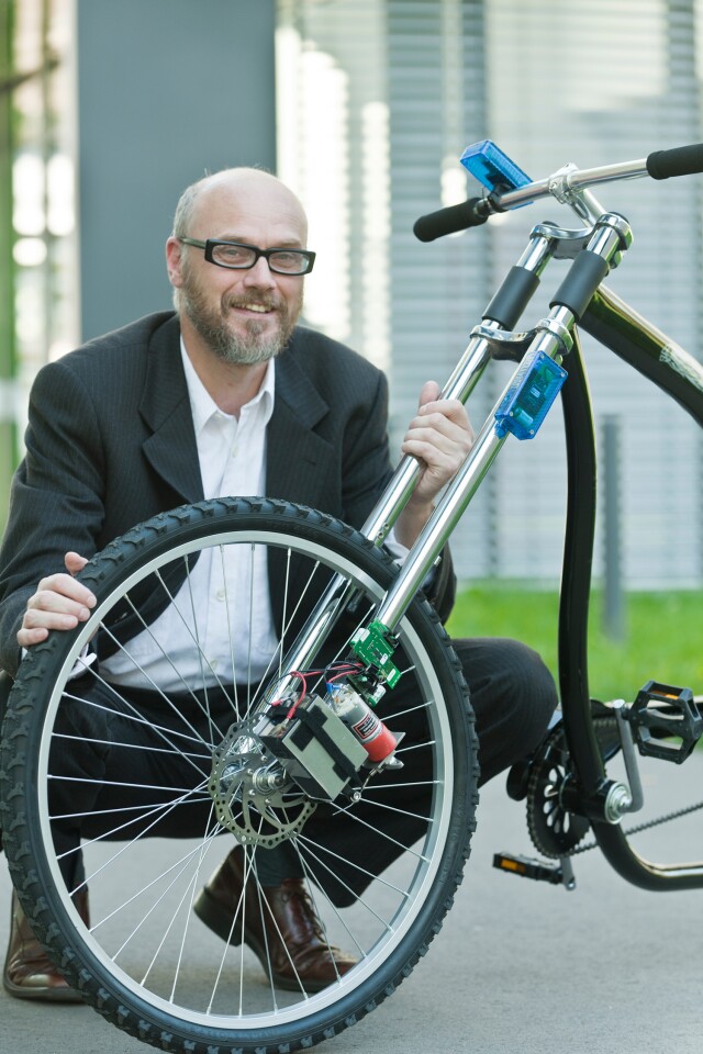 Professor Holger Hermanns with his prototype wireless bicycle braking system