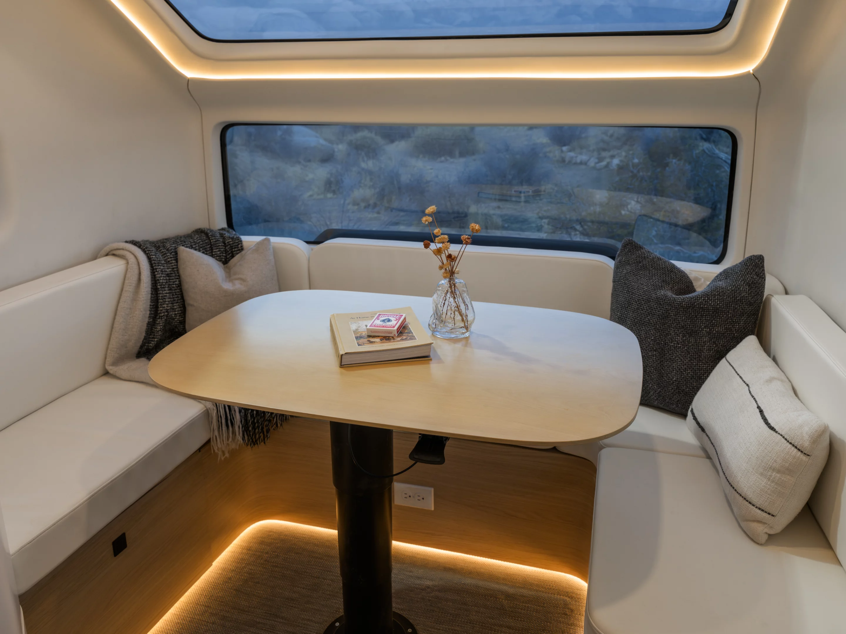 The front U-shaped sofa dinette offers scenic views and converts into the trailer's second double bed