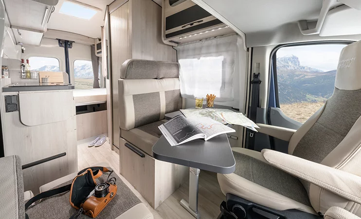 The dinette includes swivel front seats, a two-seat bench and an adjustable table