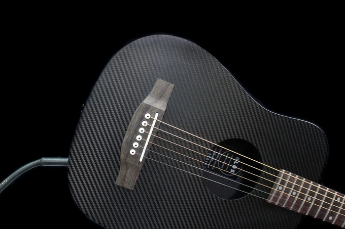 The Klos travel electro-acoustic mini dreadnought has a carbon fiber body with spruce-backed sound board
