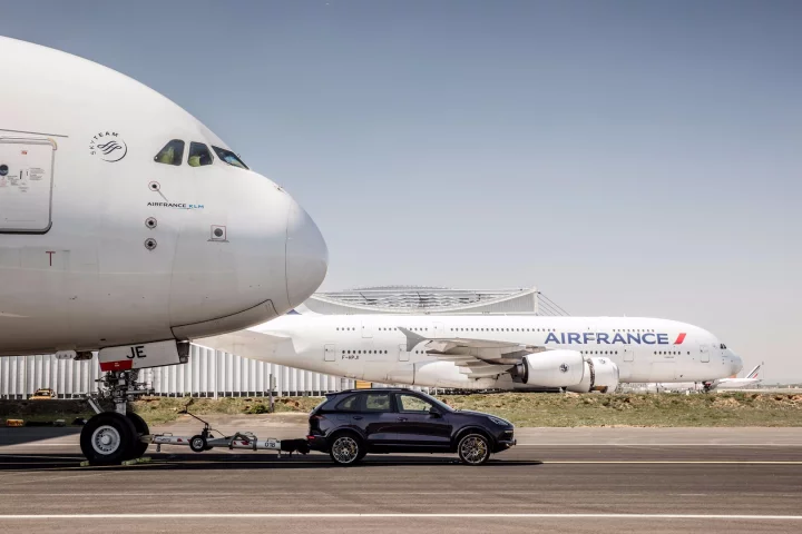 An Air France A380 being pulled by a Porsche Cayenne S Diesel