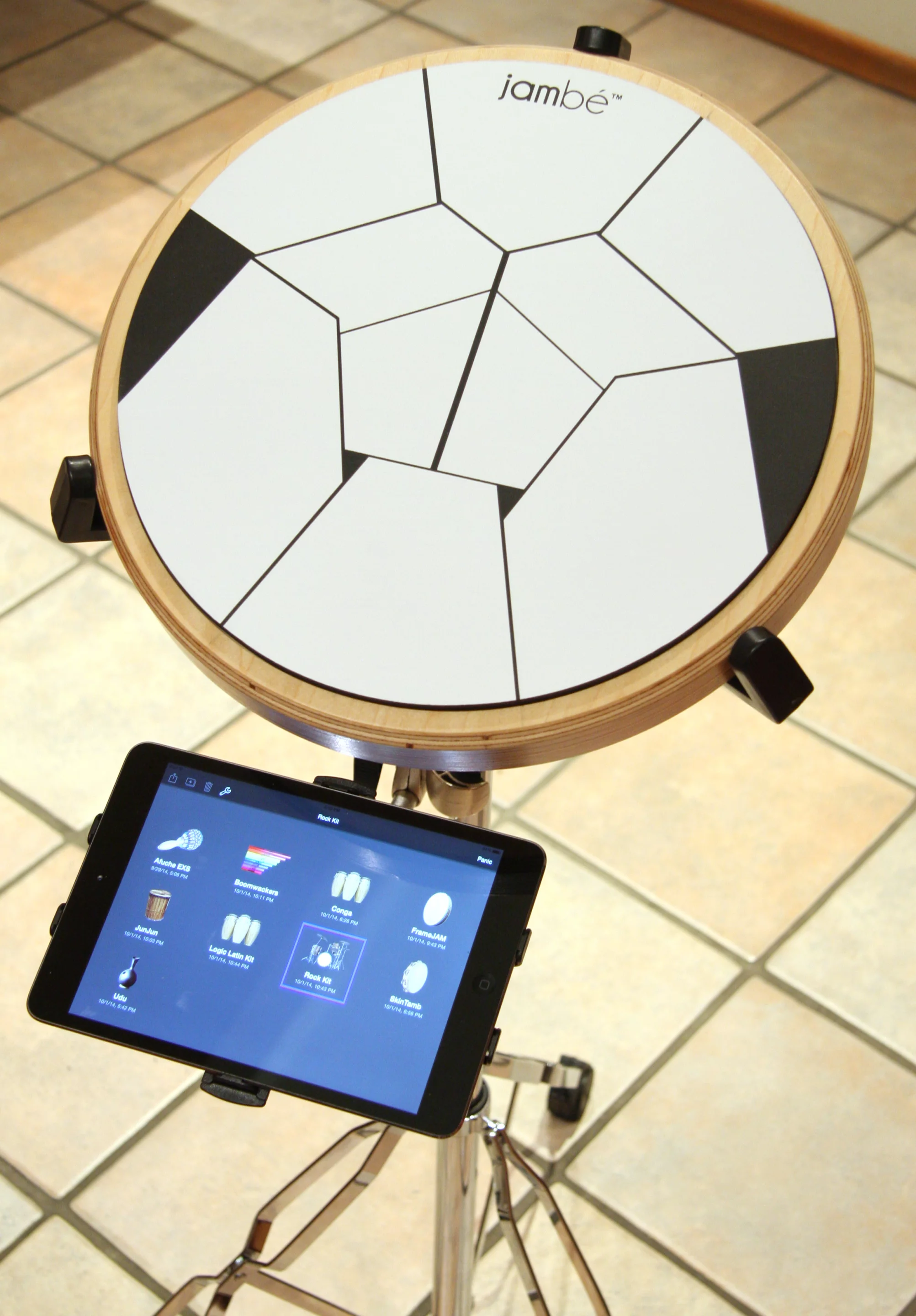 Within a sustainable hardwood rim sits a 10 geometric play zone interface which transforms actions registered by its sensors into dynamic sounds via software running on an iOS device