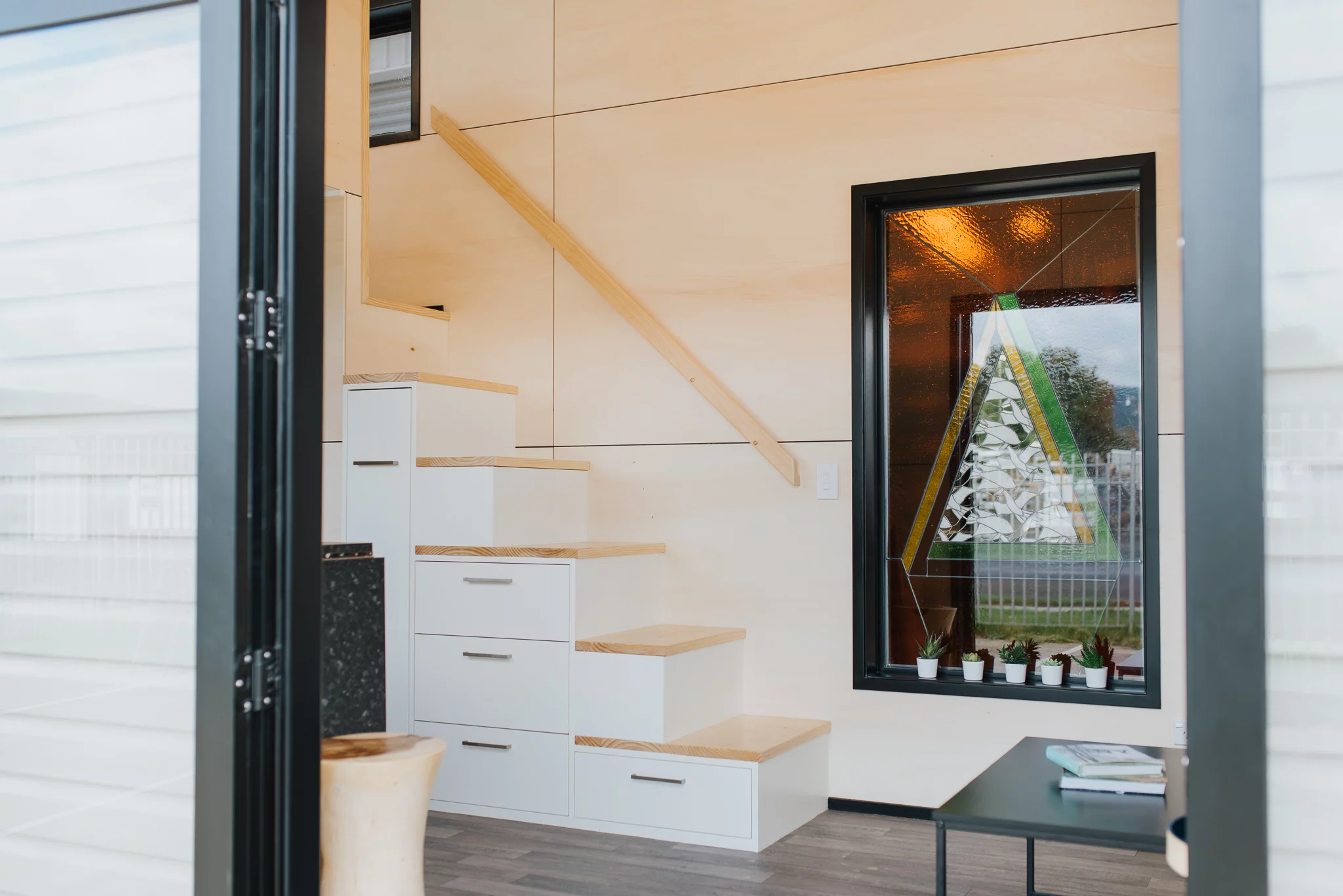 The Daisy Vera Tiny House features a storage-integrated staircase