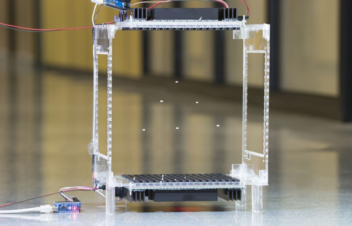 Two arrays of speakers (top and bottom) can generate the acoustic fields needed to manipulate multiple objects suspended in a 3D space