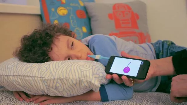 The Kinsa Smart Thermometer in use