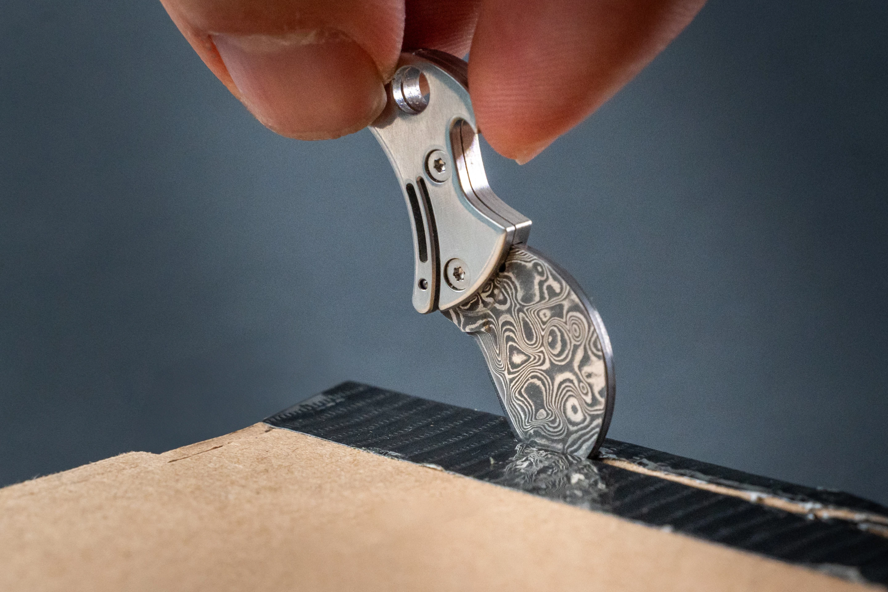 The Damascus steel blade goes to work