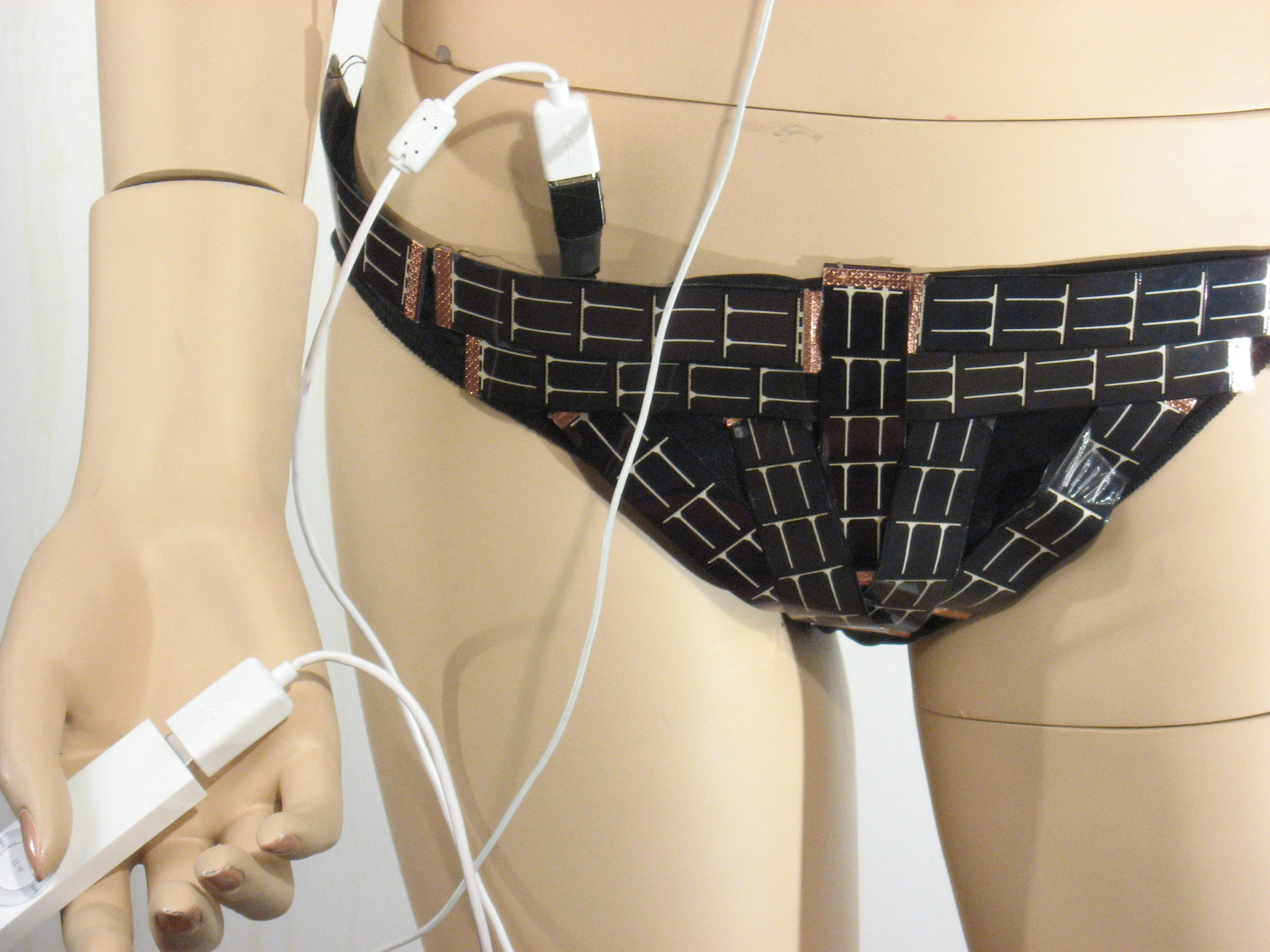 The conductive wire stitched through and connecting the photovoltaic cells of the Solar Bikini ends in a female USB port for connecting digital devices (Photo: Andrew Schneider)