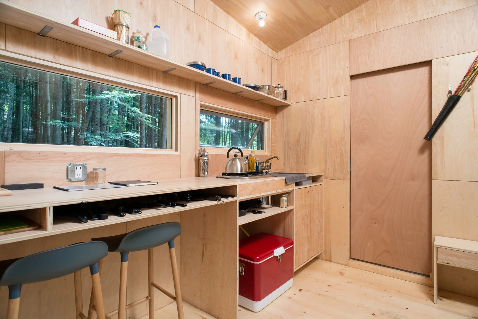 A long work surface spanning from kitchen to bedroom