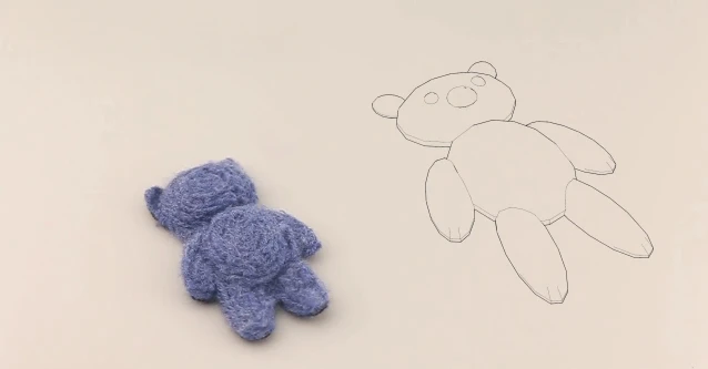 One of the finished felt teddy bears, alongside its digital model